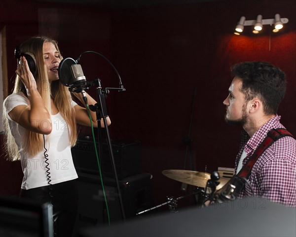 Woman singing microphone guy playing guitar