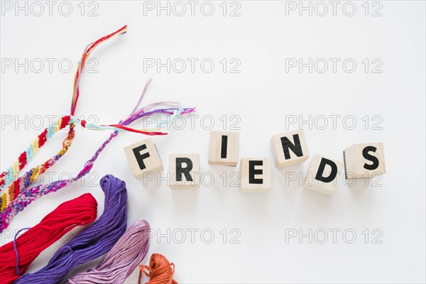 Word friends wooden blocks colorful threads