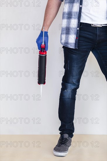 Worker holding silicone gun