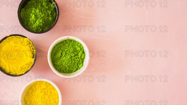 Yellow green holi color powder pink background