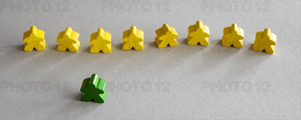 Yellow green meeple board game pieces
