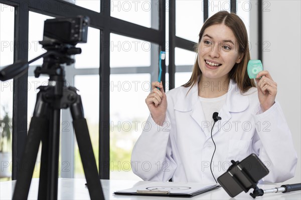 Young blogger presenting dental accessories