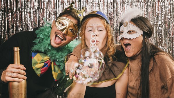 Young friends having fun carnival party