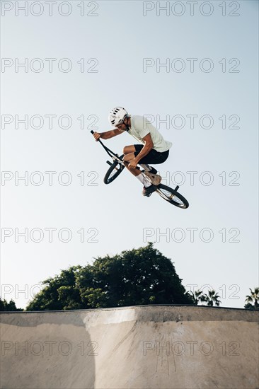 Young man jumping with bmx bike