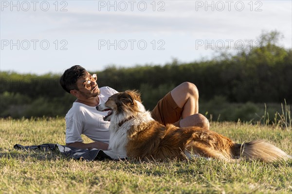 Young man with dog seaside