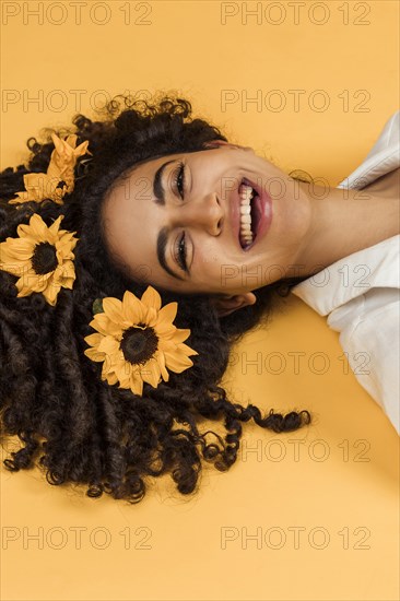 Attractive cheerful woman with flowers hair