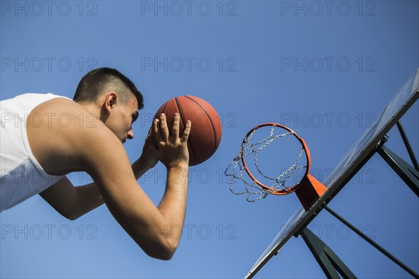 Basketball player throwing ball into net