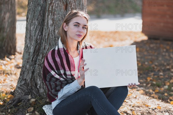 Beautiful woman holding frame with mockup