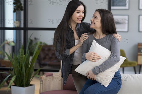 Beautiful young women smiling each other
