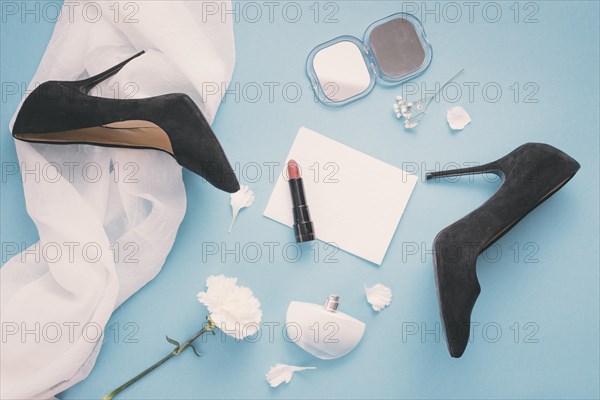 Blank paper with woman shoes lipstick table