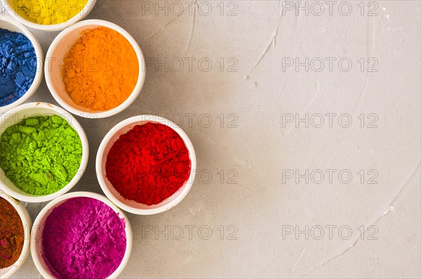 Bowls holi color powder concrete background