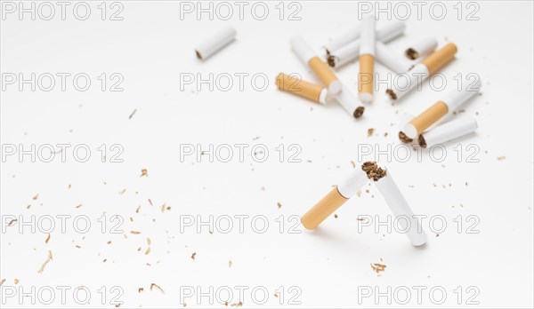 Broken cigarette tobacco white surface