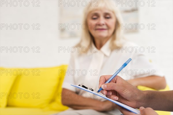 Caregiver writing clipboard close up