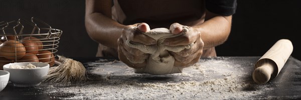 Chef using hands knead dough