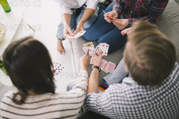 Chilling people playing cards sofa