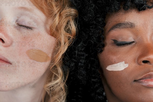 Close up african caucasian woman s face with skin tone foundation cream