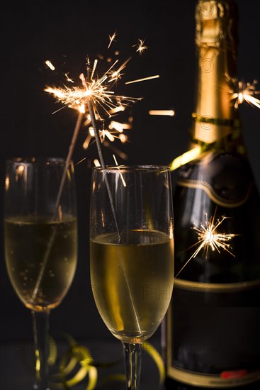 Close up champagne sparkler black backdrop