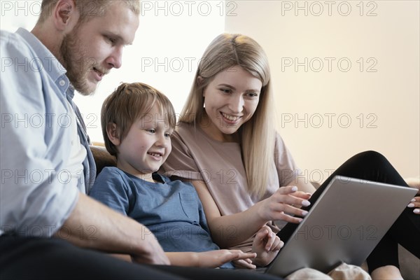 Close up parents kid with laptop