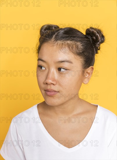 Close up woman with tied hair looking away