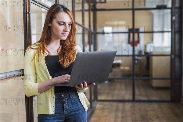 Confident businesswoman using laptop workplace