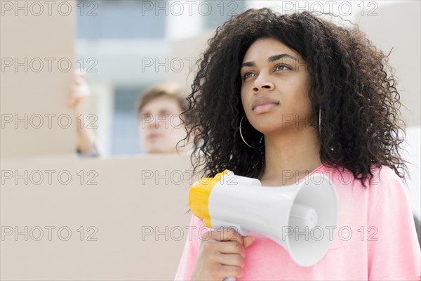 Confident woman with curly hair protesting