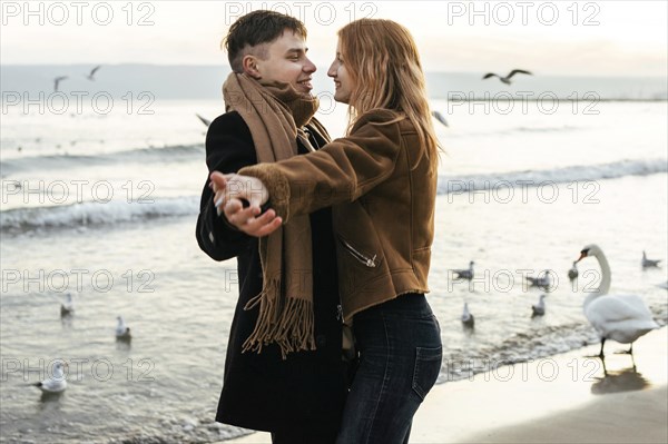 Couple dancing beach winter