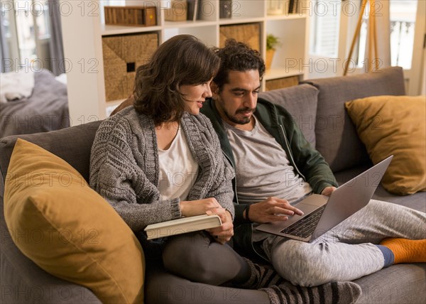 Couple watching tv show living room