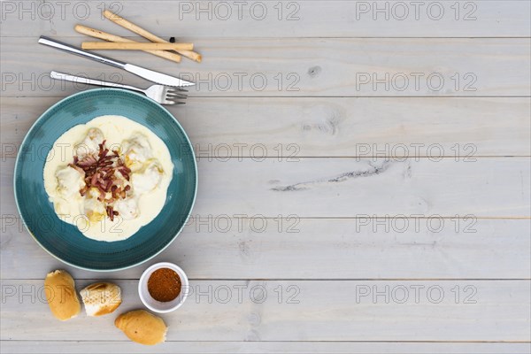 Creamy tasty italian pasta ceramic plate with bread meal wooden background