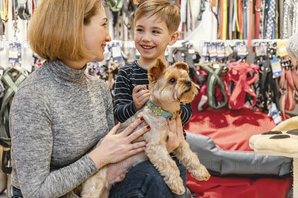 Cute little dog with owners pet shop