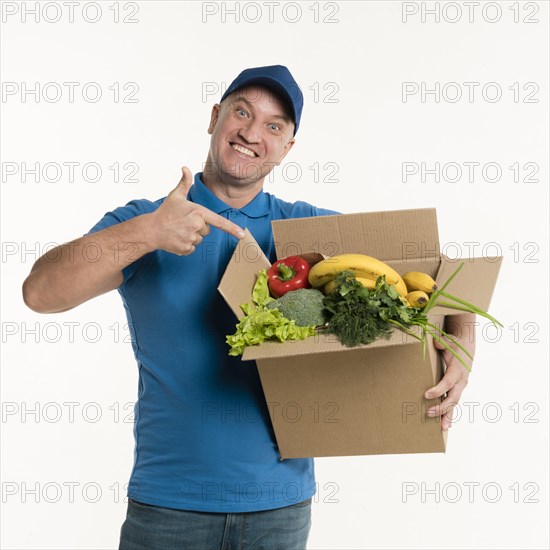 Delivery man pointing grocery box