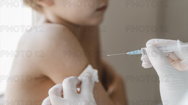 Doctor with kid getting vaccine