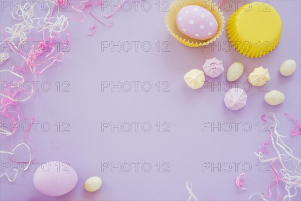 Easter eggs with small sweets purple table