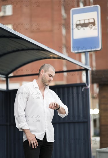 Elegant adult male waiting bus