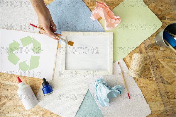 Elevated view woman s hand painting white paint mold