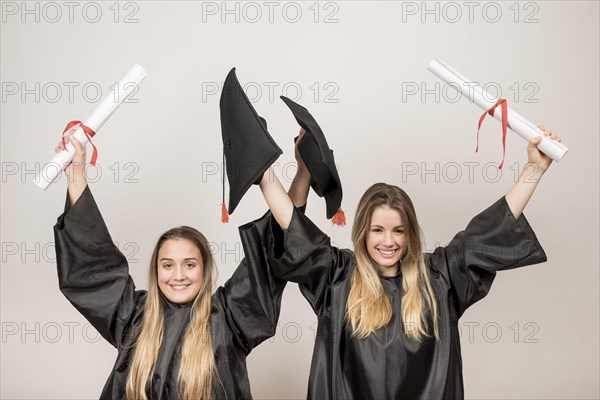 Enthusiastic graduates looking camera