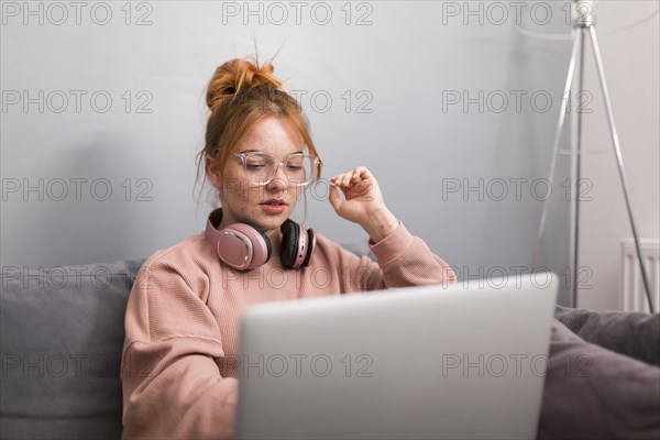 Female teacher using laptop from home hold online class