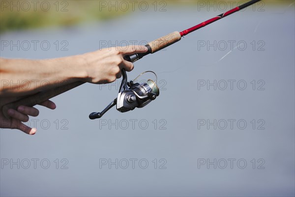 Fisherman s hand fishing blurred background