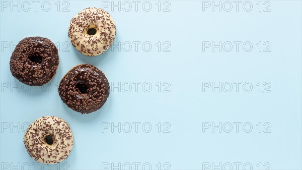 Flat lay frame with doughnuts copy space