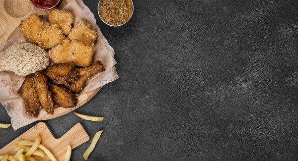 Flat lay fried chicken with french fries copy space