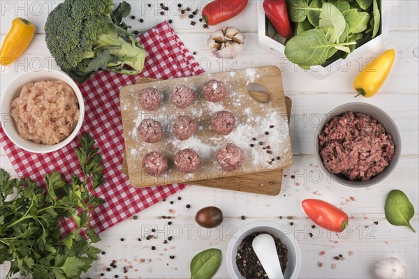 Flat lay meatballs wooden board minced meat broccoli