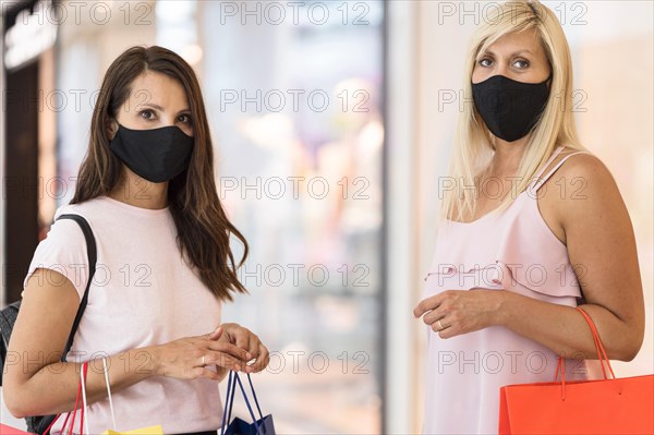 Friends wearing fabric masks mall