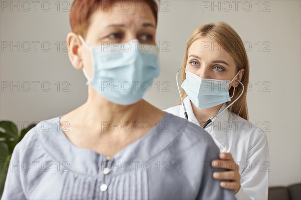 Front view elder patient with medical mask covid recovery center female doctor with stethoscope