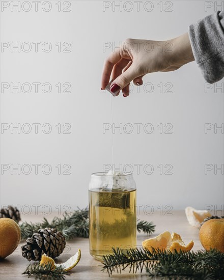 Front view person taking tea bag out jar
