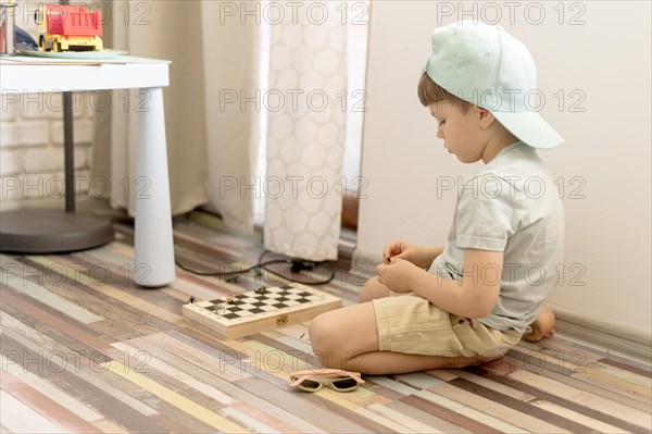 Full kid floor playing chess