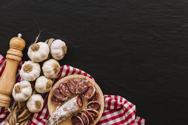 Garlic sausages near spices napkin