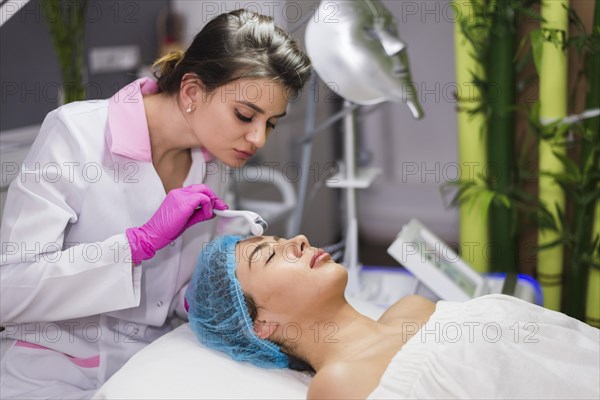 Girl receiving facial treatment beauty salon