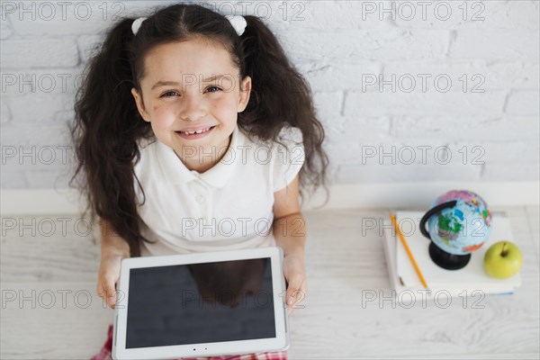 Girl sitting floor with tablet