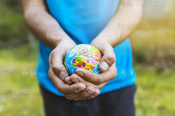 Hands carefully holding sphere