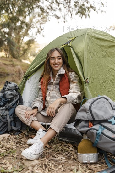 Happy camping girl forest sitting tent