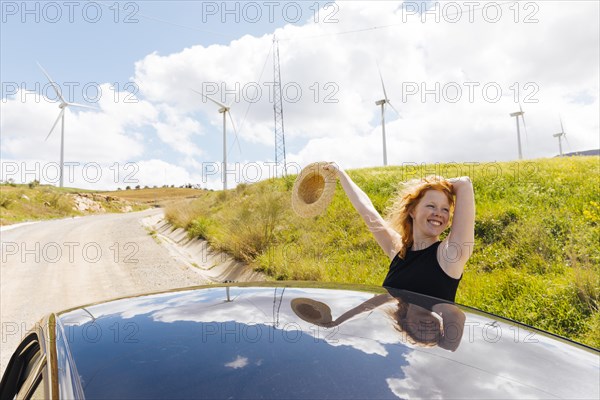 Happy red haired woman side road